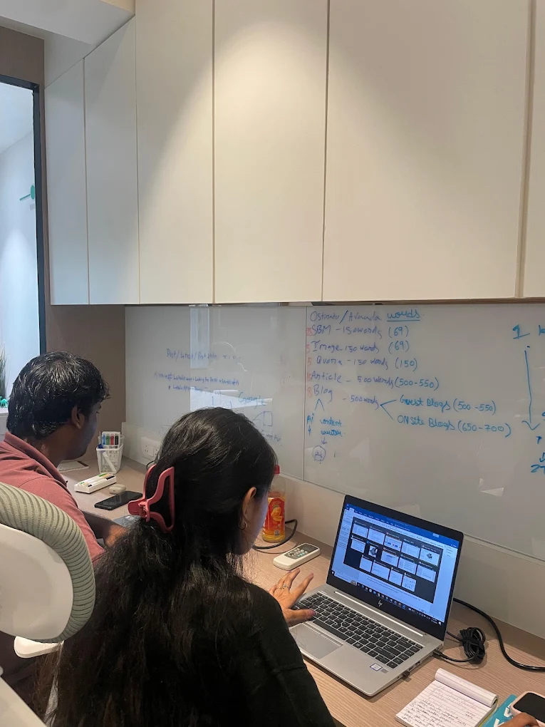 Beacon Minds team reviewing work on a laptop in the office